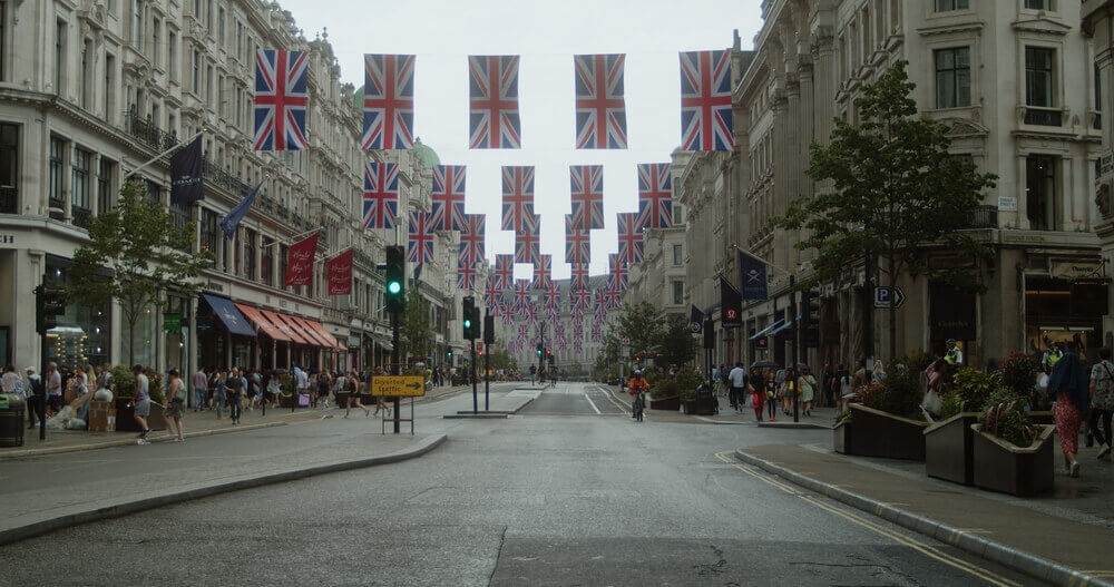 A road with Union Jack flags hanging overhead for King Charles' Coronation 2023